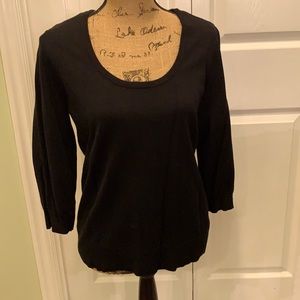 Black three-quarter sleeve scoop neck sweater.